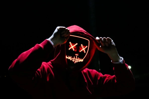 person wearing red hoodie ddos